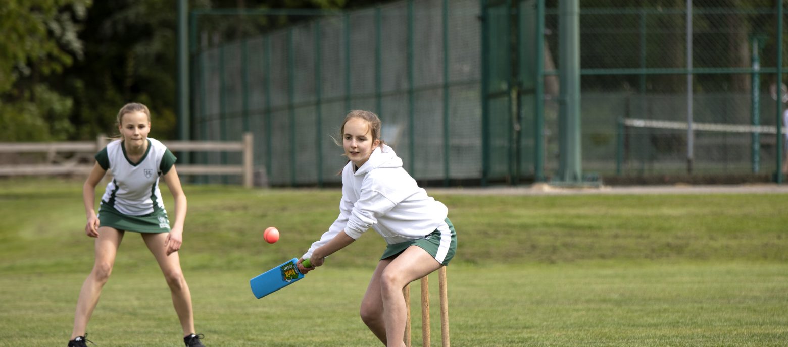 student about to hit a ball with the cricket bat
